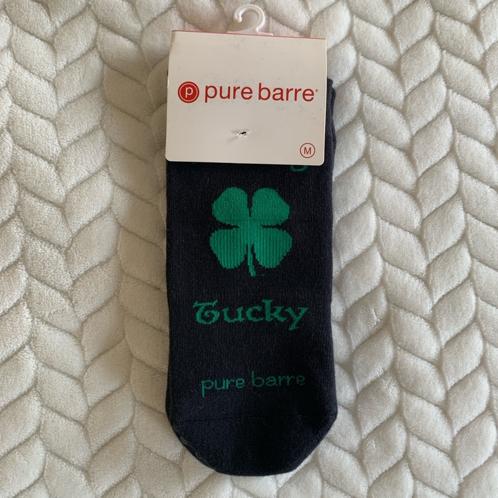 Pure Barre “Feeling Tucky” Black and Green Grip Socks with Green Clover Design